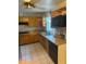 Classic kitchen featuring wood cabinets, tile flooring, and stainless steel appliances at 5811 Harcourt Ave, Orlando, FL 32839