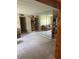 Open-concept living room with mirrors, carpet, and kitchen access, perfect for entertaining at 5811 Harcourt Ave, Orlando, FL 32839