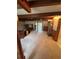 View of living room featuring carpeted floors, wooden beams, and access to the backyard at 5811 Harcourt Ave, Orlando, FL 32839