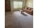 Inviting living room featuring a large window, comfortable seating, and neutral carpeting at 5811 Harcourt Ave, Orlando, FL 32839