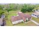 An aerial view shows the home with outbuildings, a gazebo, mature trees, and a large yard at 604 S Oxalis Ave, Orlando, FL 32807