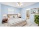 Bedroom with a queen bed, ensuite bathroom, and window at 604 S Oxalis Ave, Orlando, FL 32807