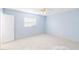 A nice bedroom with blue walls, a ceiling fan, tile flooring, and natural light from the window at 604 S Oxalis Ave, Orlando, FL 32807