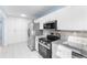 Modern kitchen boasting stainless steel appliances and ample counter space at 604 S Oxalis Ave, Orlando, FL 32807