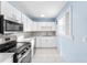 Well-lit kitchen with stainless steel appliances and light countertops at 604 S Oxalis Ave, Orlando, FL 32807