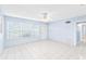 Sunny living room with tile floors and large windows at 604 S Oxalis Ave, Orlando, FL 32807