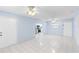Open-concept living room with tile flooring leading into a kitchen at 604 S Oxalis Ave, Orlando, FL 32807