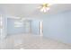 Bright living room with tile flooring, ceiling fan, and light blue walls at 604 S Oxalis Ave, Orlando, FL 32807