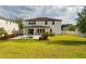 Backyard view featuring manicured lawn, landscaping, modern pool, and outdoor living space at 675 Primrose Willow Way, Apopka, FL 32712