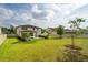 Expansive backyard featuring manicured lawn, landscaping, modern pool, and outdoor living space at 675 Primrose Willow Way, Apopka, FL 32712