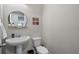 Stylish powder room featuring modern fixtures, decor and a pedestal sink at 675 Primrose Willow Way, Apopka, FL 32712