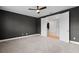 Well-lit bedroom featuring a ceiling fan, carpet, and white doors leading to a hallway at 675 Primrose Willow Way, Apopka, FL 32712
