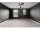 Spacious carpeted bedroom featuring a ceiling fan and two windows with lots of light at 675 Primrose Willow Way, Apopka, FL 32712