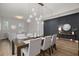 Elegant dining room featuring a modern chandelier, wainscoting, and seating for six at 675 Primrose Willow Way, Apopka, FL 32712