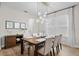 Stylish dining room with modern lighting, seating for six, and elegant decor for hosting dinner parties at 675 Primrose Willow Way, Apopka, FL 32712