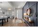 Welcoming entryway with stylish decor, wood-look floors, modern light fixtures, and neutral paint at 675 Primrose Willow Way, Apopka, FL 32712