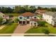 Beautiful two-story home featuring a brick driveway, three-car garage, and manicured lawn at 675 Primrose Willow Way, Apopka, FL 32712