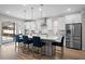 Spacious kitchen with an island, bar seating, stainless steel appliances, and modern cabinets at 675 Primrose Willow Way, Apopka, FL 32712