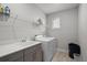 Laundry room with a new washer, dryer, sink, and a window for natural light at 675 Primrose Willow Way, Apopka, FL 32712