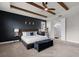Main bedroom featuring wood beam details, accent wall, ensuite bath with frameless glass shower at 675 Primrose Willow Way, Apopka, FL 32712