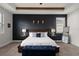 Main bedroom features a blue bench, decorative wall art, and a large bed with side tables at 675 Primrose Willow Way, Apopka, FL 32712