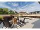 Outdoor patio with comfortable seating arrangement surrounding a wooden accent table and swimming pool at 675 Primrose Willow Way, Apopka, FL 32712