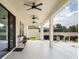Spacious covered patio with ceiling fans, decorative lighting, and outdoor seating area at 675 Primrose Willow Way, Apopka, FL 32712