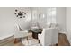 Cozy sitting area with four armchairs, a round wooden table, and a soft rug at 675 Primrose Willow Way, Apopka, FL 32712