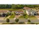 An overview of the property, complemented by mature trees, manicured lawns, and surrounding neighborhood at 675 Primrose Willow Way, Apopka, FL 32712