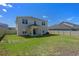 Expansive backyard featuring lush green grass, privacy fence and a covered patio, perfect for entertaining and relaxation at 683 Campo Ln, Davenport, FL 33837