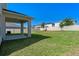 Spacious backyard with a covered patio, lush green grass, and privacy fence, perfect for outdoor enjoyment at 683 Campo Ln, Davenport, FL 33837