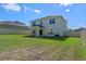 Large backyard with green grass, a covered patio, and a privacy fence, ideal for outdoor activities at 683 Campo Ln, Davenport, FL 33837