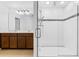 Bathroom featuring glass enclosed shower with dual sink vanity and dark cabinets at 683 Campo Ln, Davenport, FL 33837