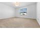 Bright bedroom featuring neutral carpet, a window with blinds, and a decorative light fixture at 683 Campo Ln, Davenport, FL 33837