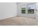 Bedroom featuring two windows and carpet at 683 Campo Ln, Davenport, FL 33837