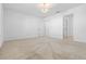 Spacious bedroom with neutral carpet, bright lighting, and an open doorway at 683 Campo Ln, Davenport, FL 33837