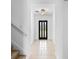 Bright entryway with decorative lighting, clean white walls, and tile flooring leads to the front door at 683 Campo Ln, Davenport, FL 33837