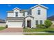 Charming two-story home boasts a well-manicured lawn and an attached two-car garage at 683 Campo Ln, Davenport, FL 33837