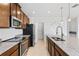 Modern kitchen features granite countertops, stainless steel appliances, and an island with sink at 683 Campo Ln, Davenport, FL 33837