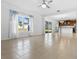 The bright living room has tile flooring, a ceiling fan, and view into a modern kitchen at 683 Campo Ln, Davenport, FL 33837