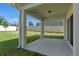The covered patio overlooks a fenced yard, offering a relaxing outdoor space for leisure and entertainment at 683 Campo Ln, Davenport, FL 33837