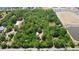 Aerial view of a wooded lot with a single-story home and surrounding amenities at 736 Guy Rd, Orlando, FL 32828