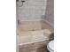 Enclosed bathtub area with tile surround and tile flooring at 736 Guy Rd, Orlando, FL 32828