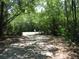 Gated driveway entrance to the property surrounded by lush greenery at 736 Guy Rd, Orlando, FL 32828