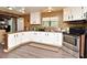 Well-lit kitchen with white cabinets, modern appliances, and a cozy breakfast bar at 736 Guy Rd, Orlando, FL 32828