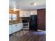 Bright kitchen with white cabinetry, stainless steel appliances, and brick accent wall at 736 Guy Rd, Orlando, FL 32828