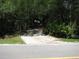 Gated driveway with mature landscaping for privacy at 736 Guy Rd, Orlando, FL 32828