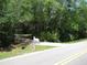 Gated driveway with mature landscaping for privacy at 736 Guy Rd, Orlando, FL 32828