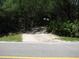 Gated driveway with mature landscaping for privacy at 736 Guy Rd, Orlando, FL 32828