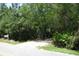 Gated driveway with mature landscaping for privacy at 736 Guy Rd, Orlando, FL 32828